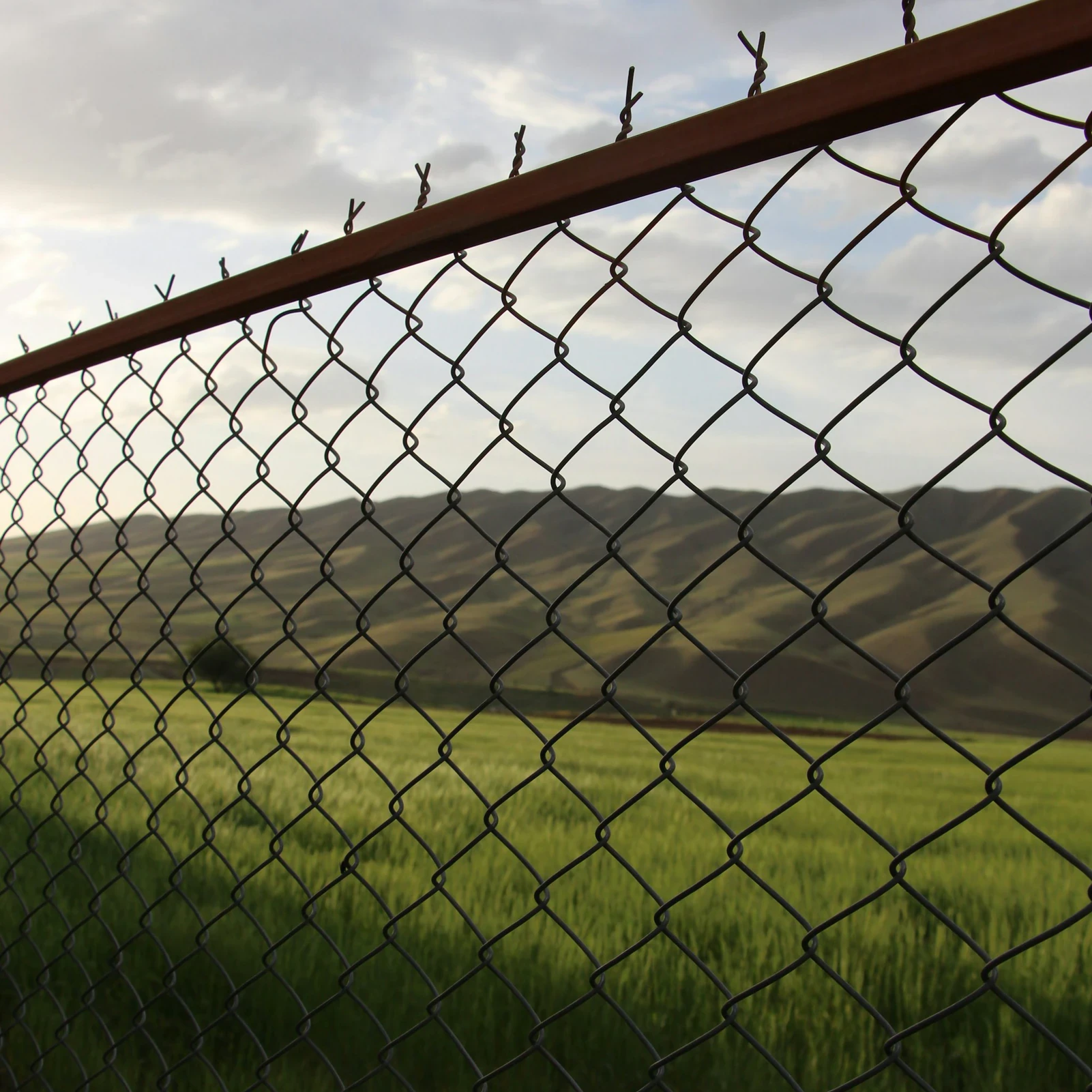Chain link fence with barbed wire on a commercial site